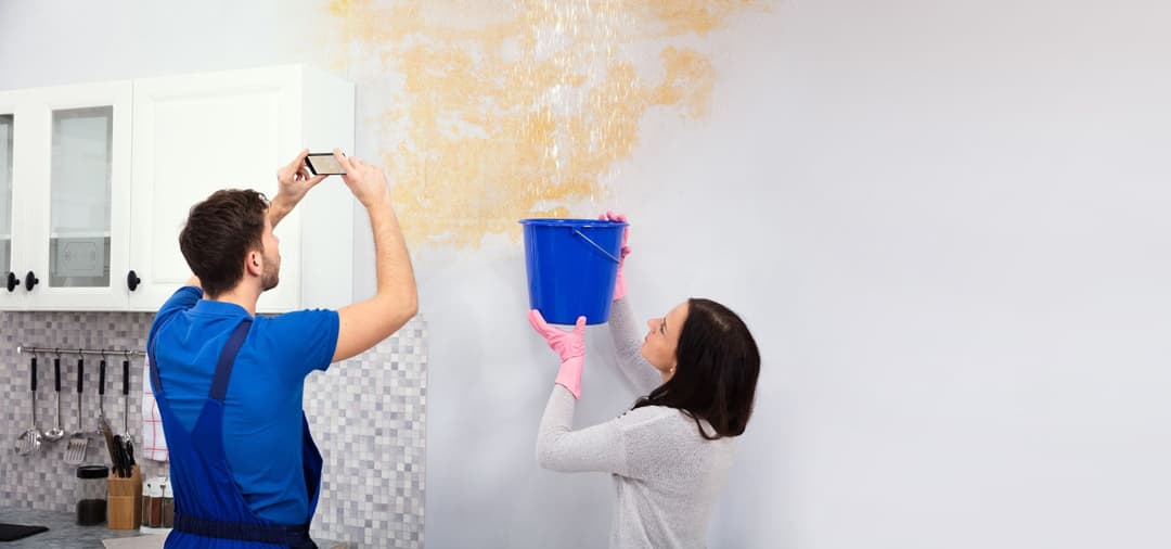 Water damage technician documenting property inspection